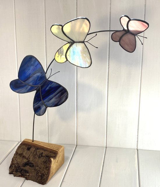 Copper foiled stained glass butterflies on a reclaimed wooden base made by Vitreus Art