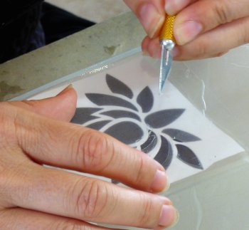 Create areas of glass frosting by cutting out areas of etch resist