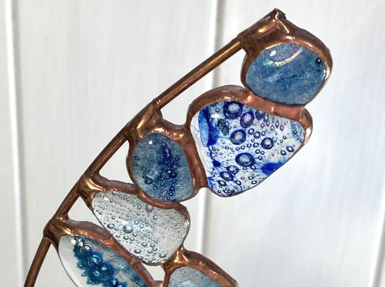 Copper foiled blue fused glass globs on a reclaimed wooden base made by Vitreus Art