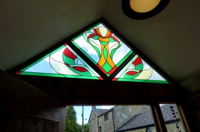 A large triangular porch window created in three sections by Vitreus Art